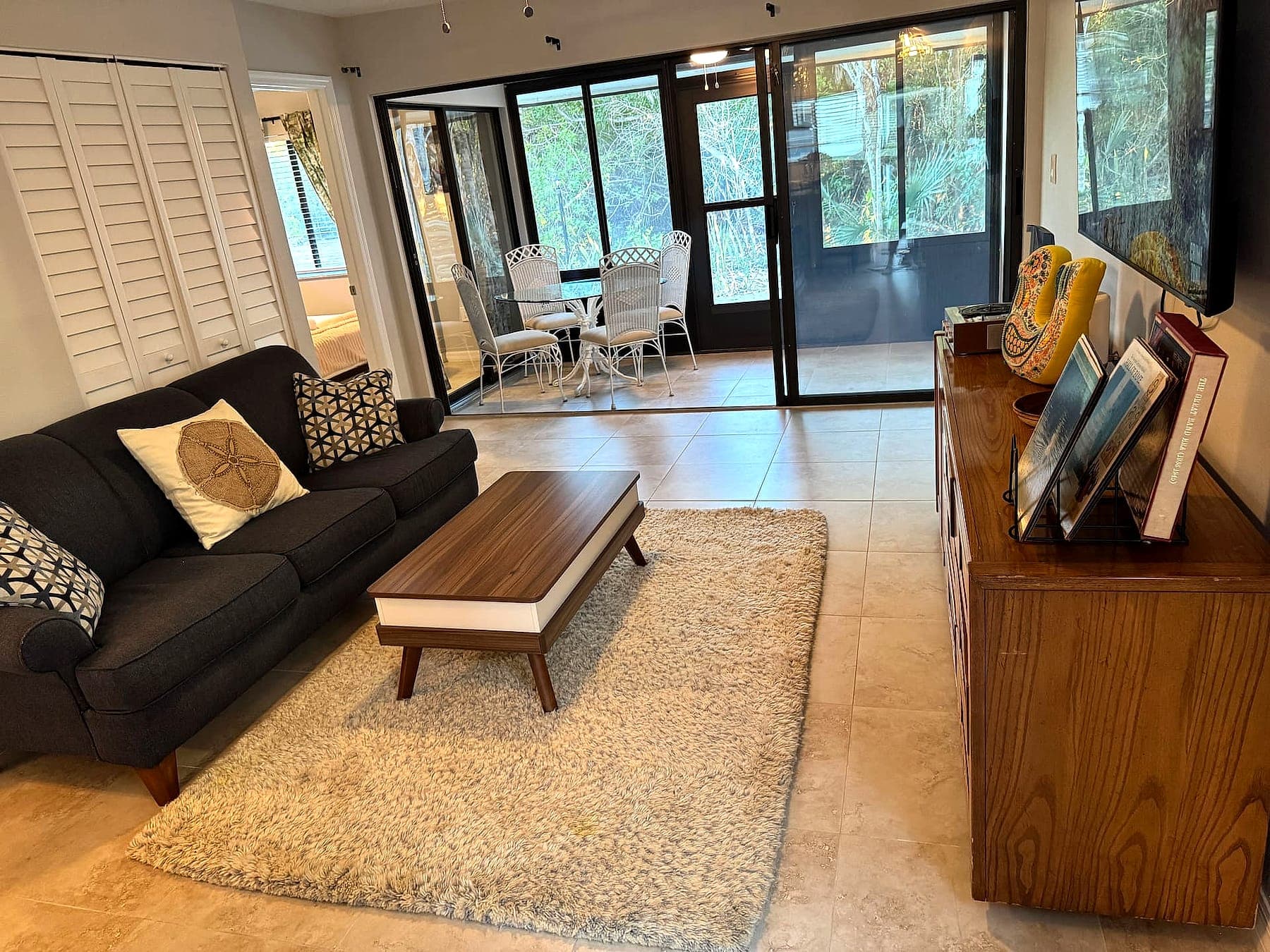 Living room opening through sliders to the screened lanai at Charlotte Harbor Villa