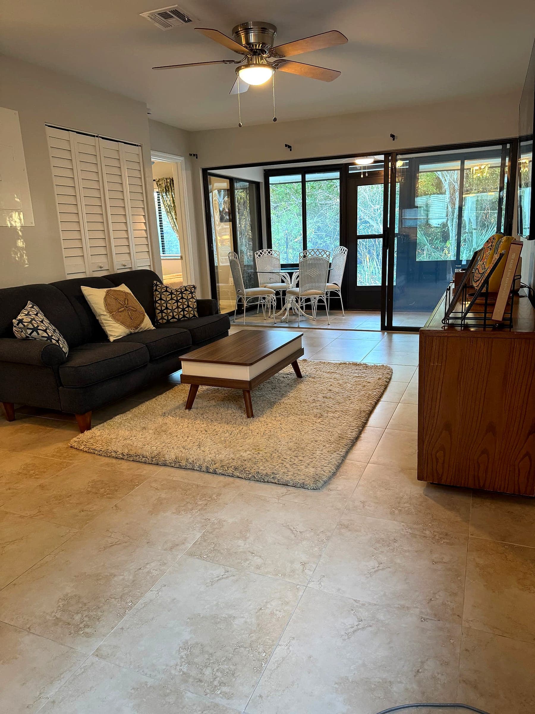 Open living room flowing to the screened lanai at Charlotte Harbor Villa