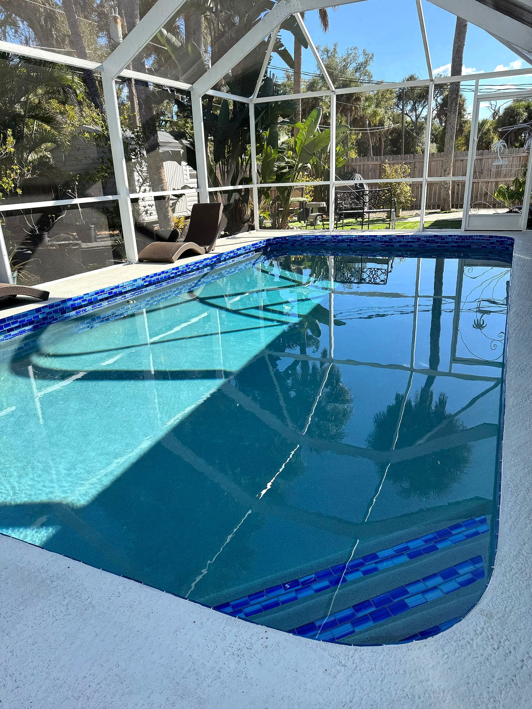 Screened, glass-tiled pool at the Tropical Pool Home