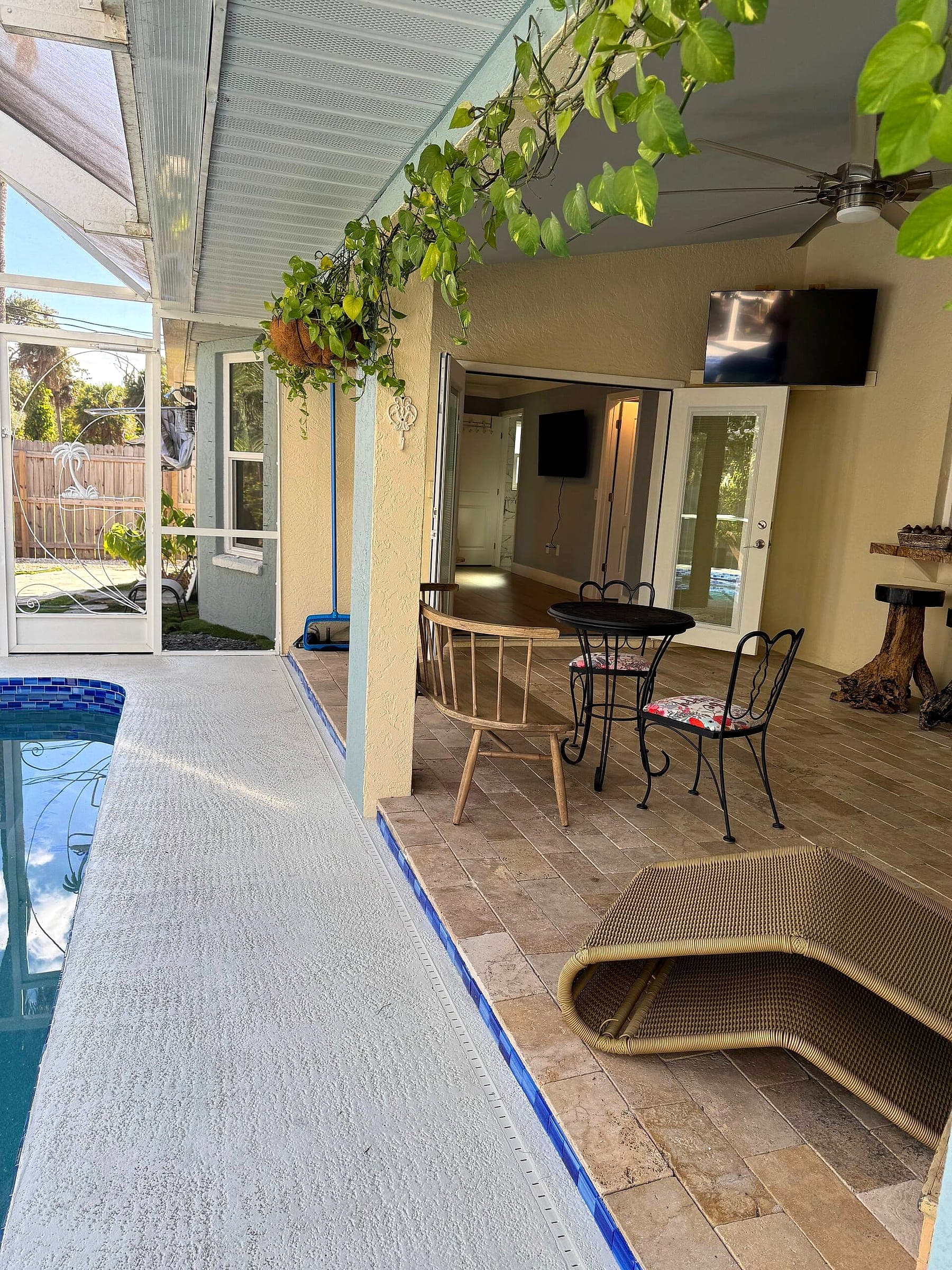 Pool deck looking into the covered lanai at dusk