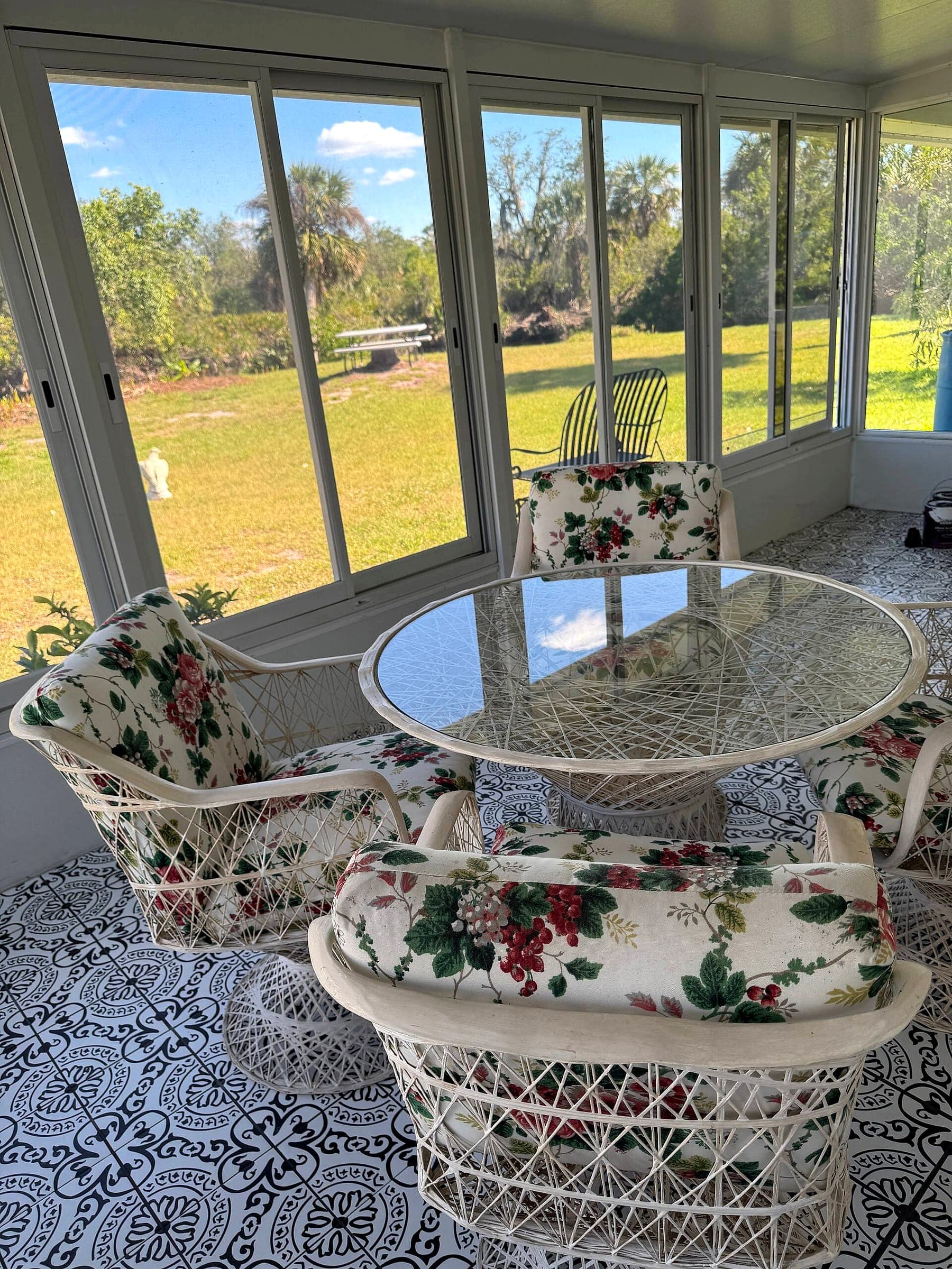 The screened sunroom at Your Sanctuary, overlooking the back lawn